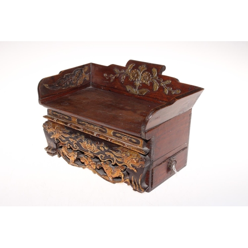 220 - Chinese box in the form of a settle with gilt highlighted carved decoration and secret drawer to the... 