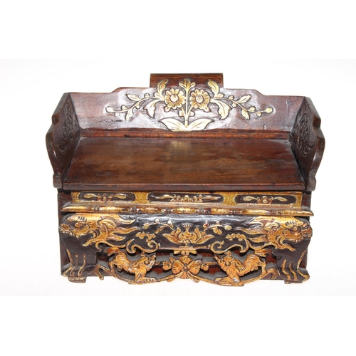 220 - Chinese box in the form of a settle with gilt highlighted carved decoration and secret drawer to the... 