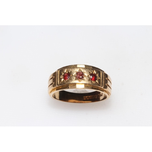 245 - 9 carat gold three stone garnet ring, size T.