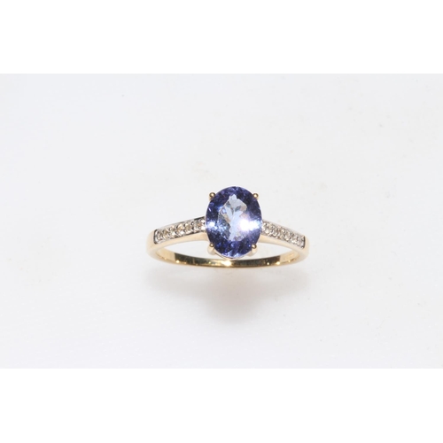 253 - Tanzanite and diamond 14k yellow gold ring, the approximate 1.9 carats tanzanite with twelve diamond... 