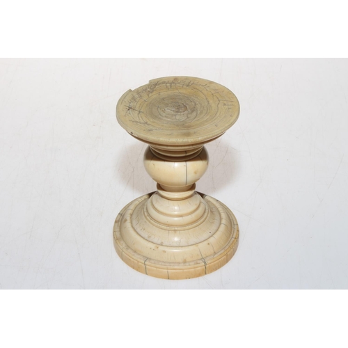 295 - Antique turned ivory stand, 10cm.   Condition: 1.5cm piece out of rim.