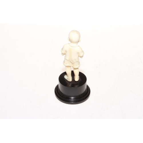 311 - 1920's well carved ivory figure of young boy with fish, on plinth base, 13cm.