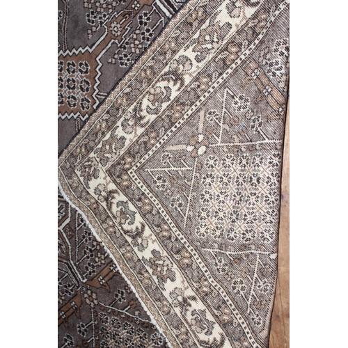 382 - Persian design wool carpet with a brown ground, 3.10 by 2.05.