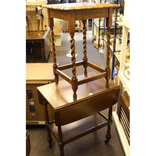 427 - Two similar oak drop leaf trolleys and two oak occasional tables (4).