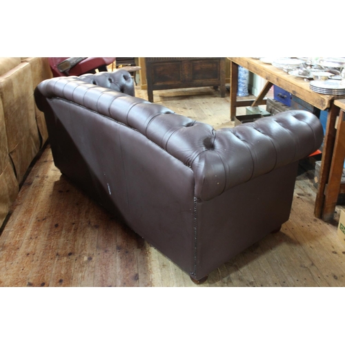 453 - Brown deep buttoned leather three seater Chesterfield settee, 86cm by 192cm by 82cm, (paint flecks t... 