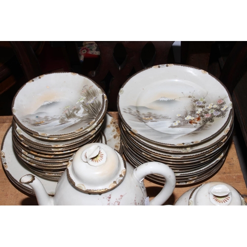 54 - Japanese eggshell thirty nine piece tea set with birds and foliage in landscape decoration.