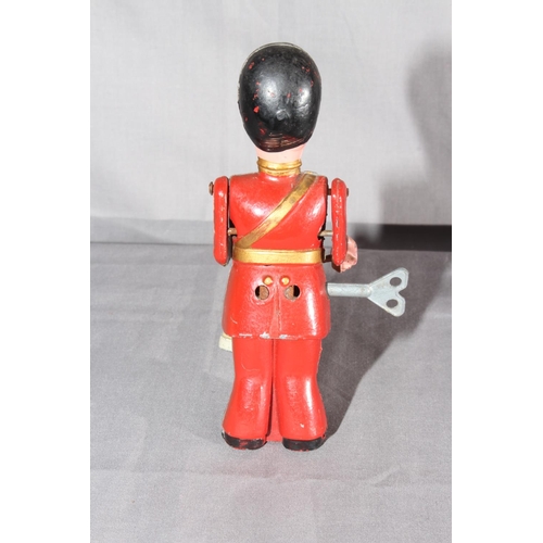 12 - Moko Clockwork die-cast Drumming Guardsman.   Excellent clockwork motor works.