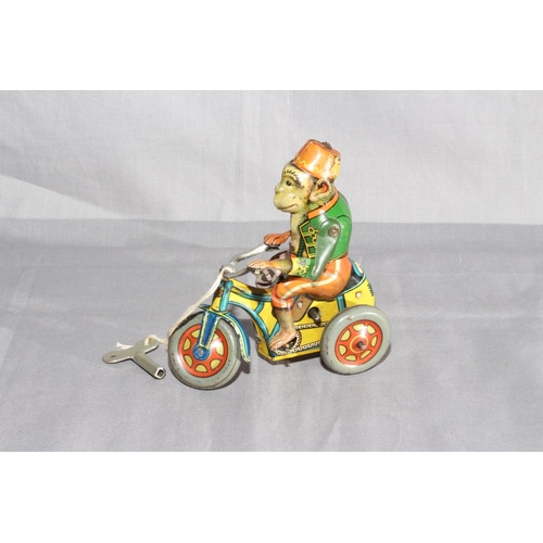 19 - Arnold Germany US Zone clockwork tinplate Monkey on Tricycle.   Very Good clockwork motor works.