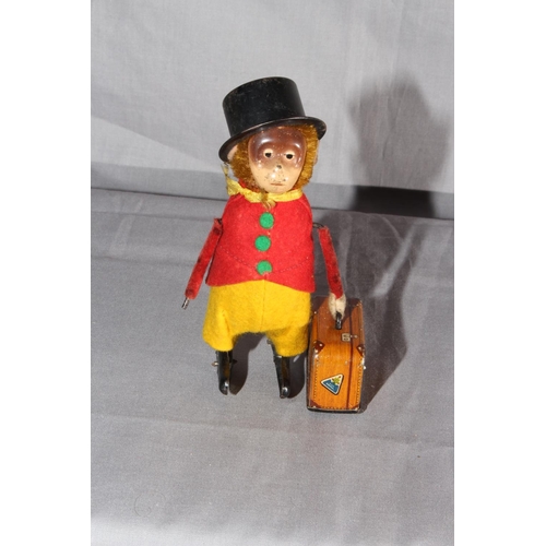 21 - Schuco clockwork Monkey with Suitcase.   Original clothes.  Excellent clockwork motor works.