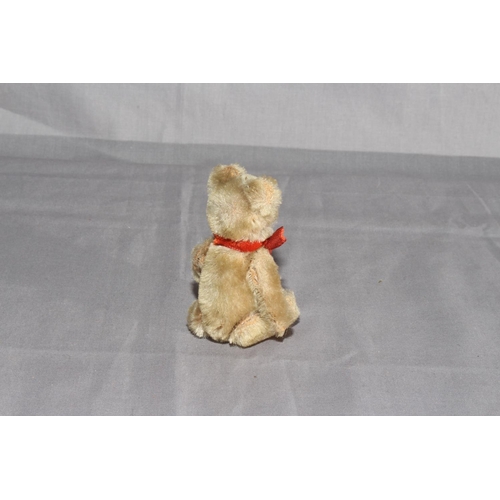 26 - 1930s Schuco Jointed Teddy Bear.  Mohair with Red Ribbon.  Excellent.