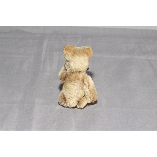 27 - 1930s Schuco Jointed Teddy Bear.  Mohair with Black Lace Ribbon.   Excellent.