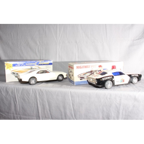 60 - 2 Taiyo Japan battery operated Non Fall Mystery Bump Go Cars.  Oldsmobile Toronado and Highway Patro... 