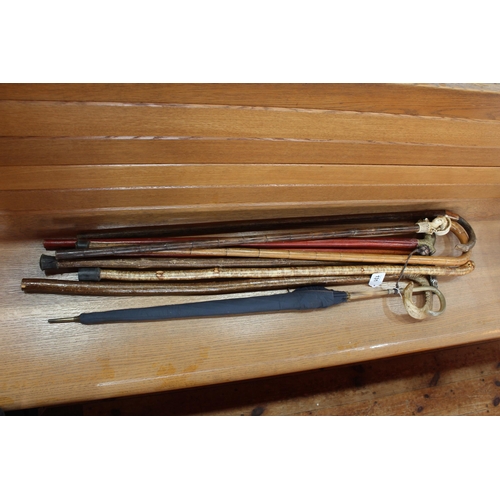 131 - Collection of walking canes including horn and brass bound.