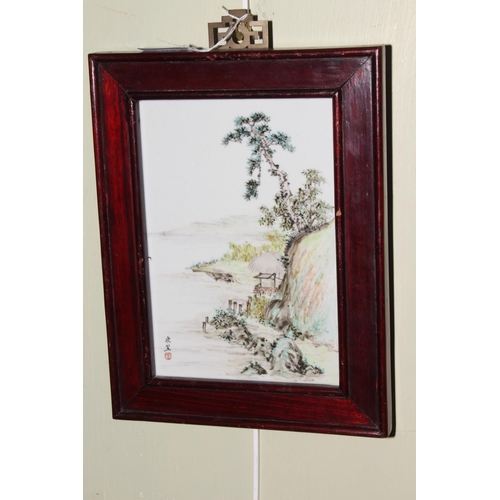 172B - Small Chinese porcelain plaque depicting lake edge and cliffs, signed bottom left.