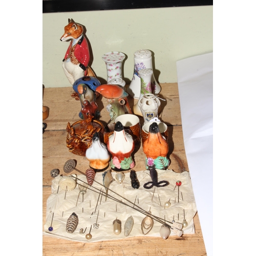 49 - Collection of hat pins and four stands, modern fox stirrup cups, bird ornaments, etc.