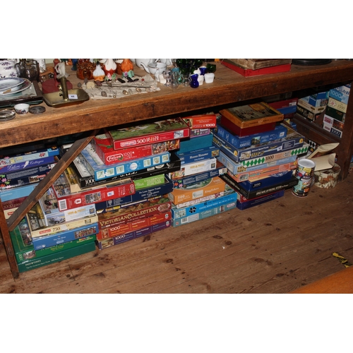 54 - Large collection of approximately one hundred jigsaw puzzles.