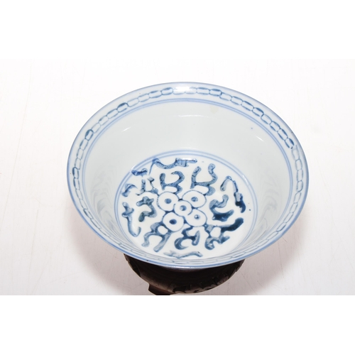 166 - Chinese blue and white bowl with carved wood stand, 16.5cm diameter.