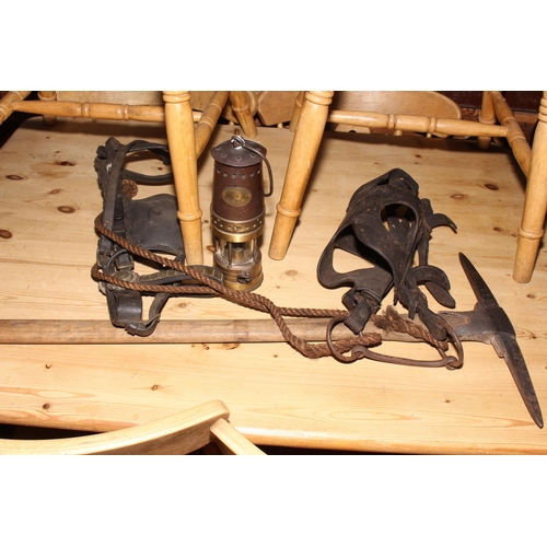 128 - Miners lamp, pick, protective head gear, horse bridle, etc.