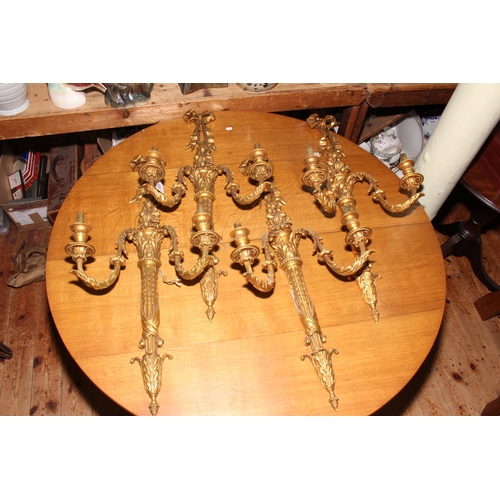 131 - Four large gilt wall lights, 75cm length.