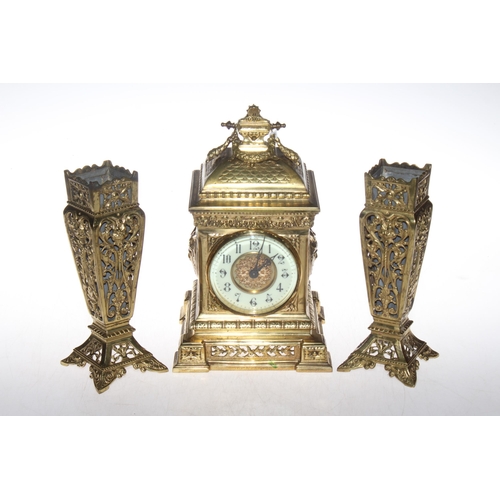 147 - Ornate gilt metal three piece garniture clock set, clock 27cm high.