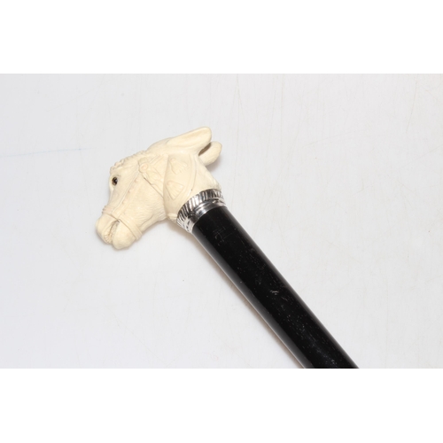 244 - Late Victorian silver mounted cane having carved ivory pony with glass eyes handle, Birmingham 1899.