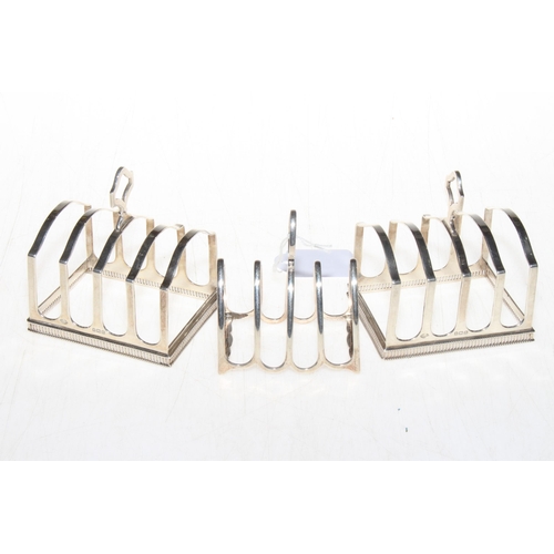 258 - Pair of silver five bar toast racks, Birmingham 1929, and small toast rack, Sheffield 1919 (3).