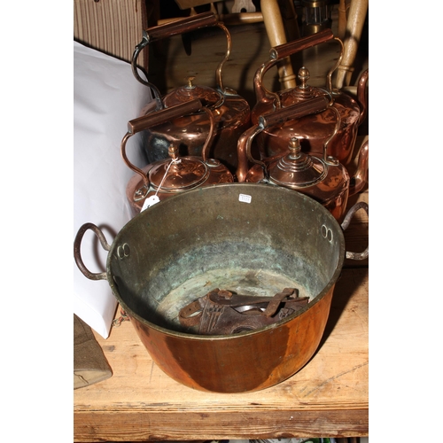 34 - Four Victorian copper kettles, brass jam pan, and farrier's horseshoe and nails in leather holder.