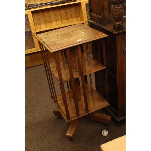 355 - Edwardian oak revolving two tier book table, 89cm by 45cm by 45cm.