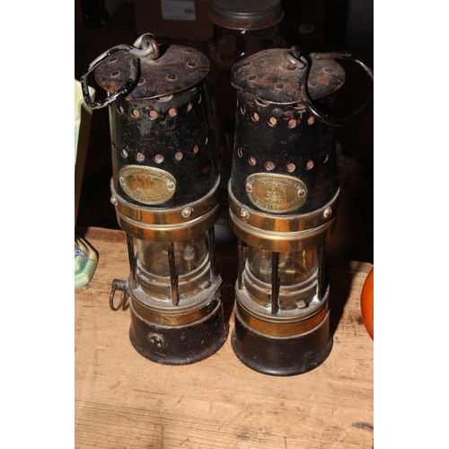 42 - Pair of Patterson and pair of Protector Lamp and Lighting Co. miners lamps and another lamp.