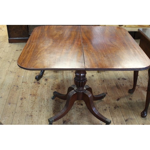 431 - 19th Century mahogany fold top tea table on turned pedestal to four reeded scrolled legs, 74cm by 86... 