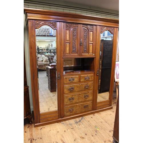 459 - Victorian carved walnut wardrobe having two carved panel central doors above five drawers flanked by... 