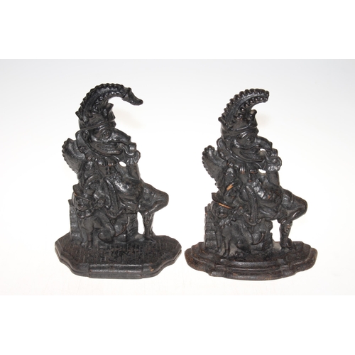 171 - Two cast iron punch door stops, 31cm high.