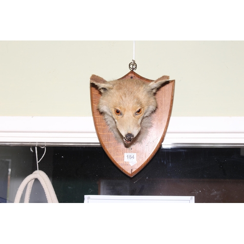 184 - Taxidermy mounted fox head and an inlaid mahogany plant stand, 94cm high.