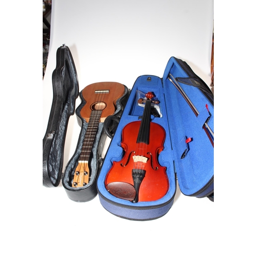 188 - The Stentor Student 1 violin with bow, cased, and a child's guitar in case.