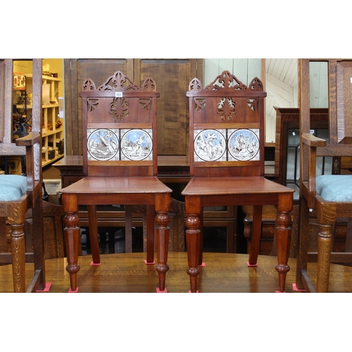 553 - Pair Victorian mahogany hall chairs with Minton? tiled inset backs.