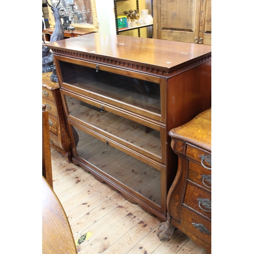 558 - Early 20th Century mahogany bookcase having hinged top above three drop down glazed panel doors, 112... 