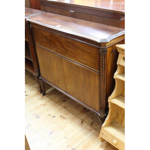 567 - Mahogany shaped top cabinet having fall front above two cupboard doors on cabriole legs, 99cm by 107... 