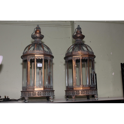 74 - Pair of metal and glazed hanging lanterns, approximately 62cm high.