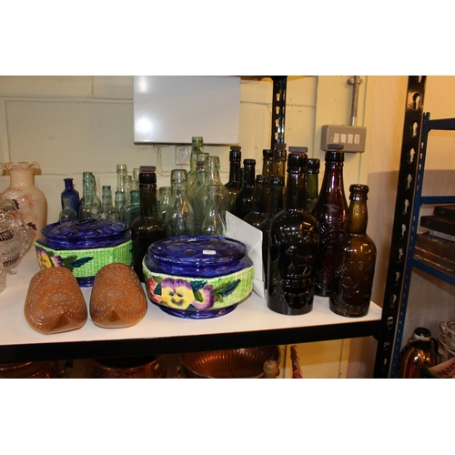 105 - Glass bottles including beer, Ringtons pottery, carved clogs, etc.