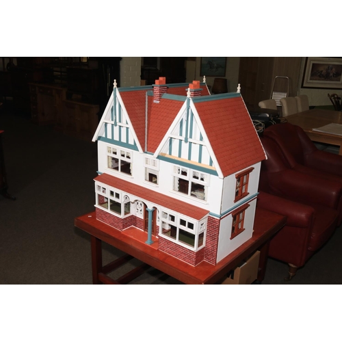 126 - Large Elizabethan style dolls house with electrics on portable stand.