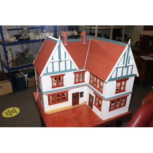 126 - Large Elizabethan style dolls house with electrics on portable stand.