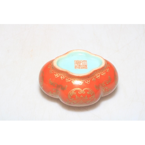 167 - Chinese red glazed ink box with gilt decoration, Qianlong mark to base, 5cm high.