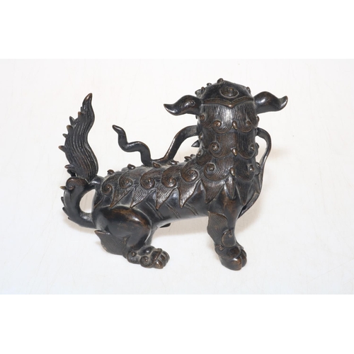 172 - Chinese bronze foo dog, with snake, 17cm across.