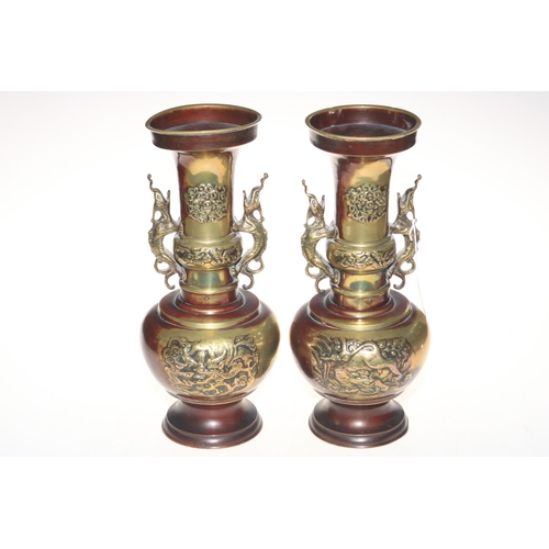 177 - Pair large Oriental metal vases with creature handles and relief decoration, 35cm.