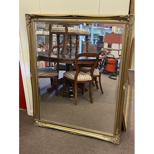 363 - Rectangular gilt framed bevelled wall mirror, 131cm by 106cm including frame.