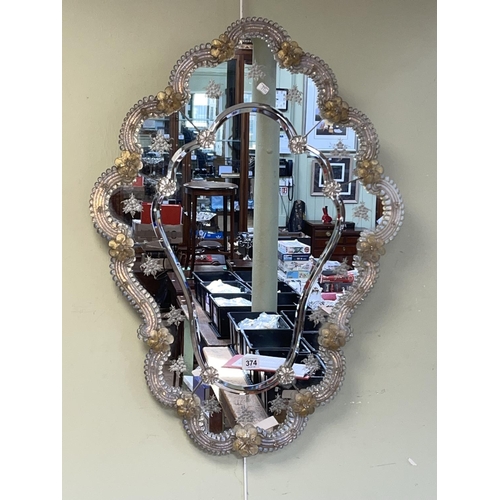 374 - Venetian style marginal wall mirror with applied coloured glass and floral frame, 78cm by 58cm.