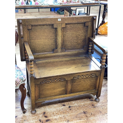 385 - Oak monks bench with bobbin pillars, 71cm by 92cm by 48cm (closed).