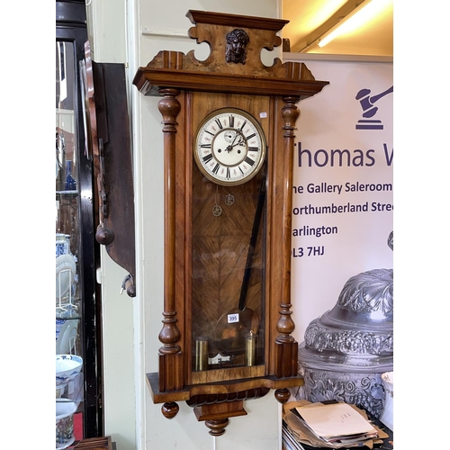 395 - Victorian walnut cased double weight Vienna wall clock, 113cm by 49cm.