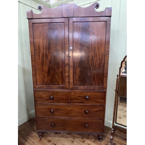 423 - Victorian mahogany linen press having two panelled doors enclosing five sliding trays above a base o... 