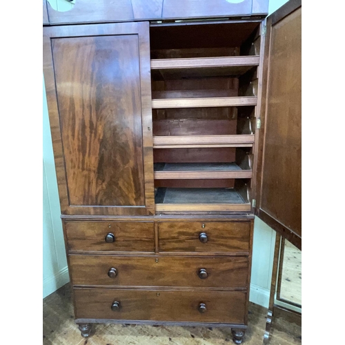 423 - Victorian mahogany linen press having two panelled doors enclosing five sliding trays above a base o... 